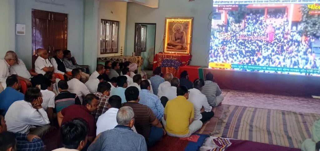 People watching live telecast of Chaldol Yatra through projector.